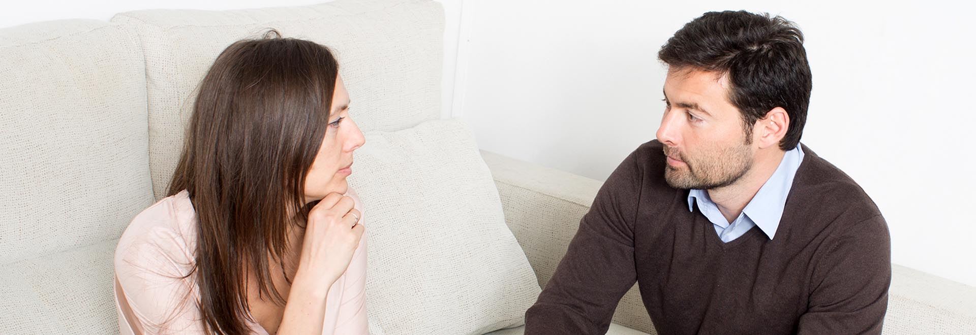  couple in difficult discussion on a sofa